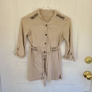 Tan shirt with metal embellishments